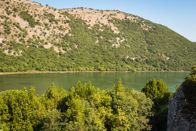 Scenic view of lake and trees against mountain
