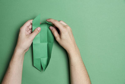 Close-up of woman hand over green background