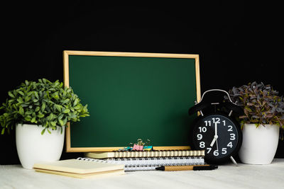 Close-up of potted plant on table against black background