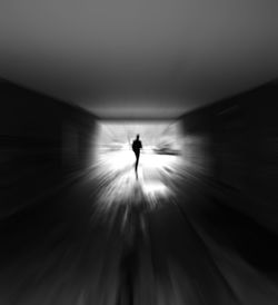 Silhouette of person in tunnel