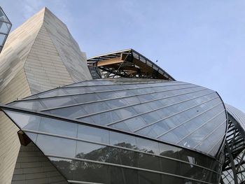 Low angle view of modern building against clear blue sky