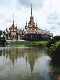 View of temple building against cloudy sky