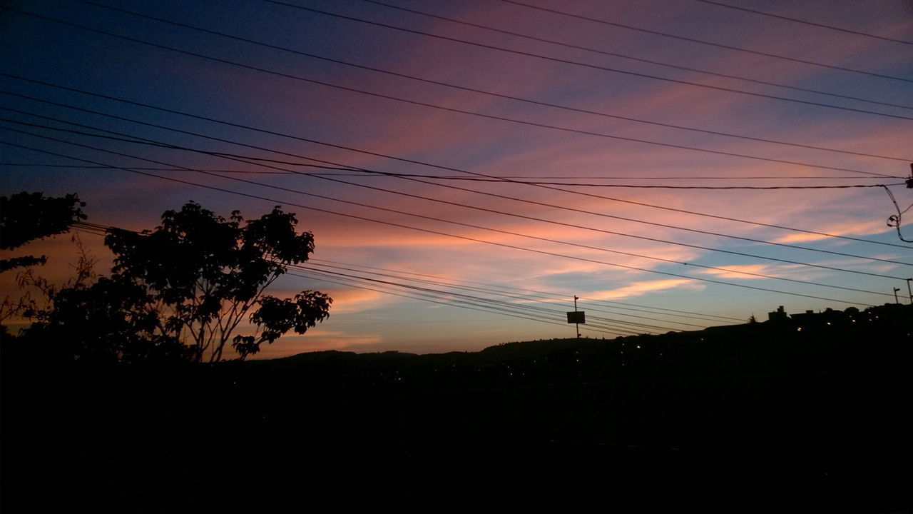 LOW ANGLE VIEW OF SILHOUETTE ELECTRICITY PYLON AGAINST SKY