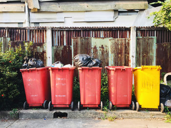 Garbage bin against building