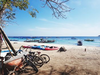 Bicycles on beach against sky