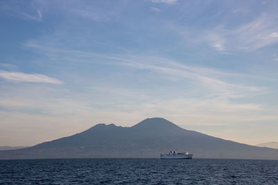 Sailboat in sea against vesuvio and  sky