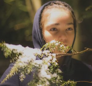 Girl by plant looking away