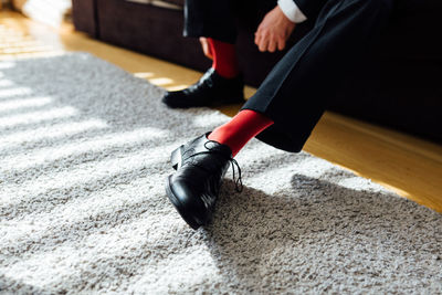 Low section of man sitting at home