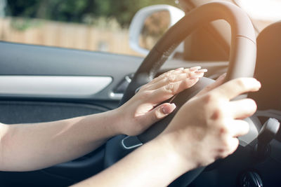 Midsection of woman holding car