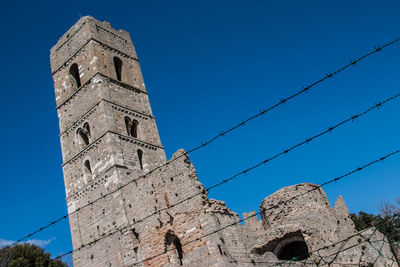 Low angle view of tower against clear blue sky