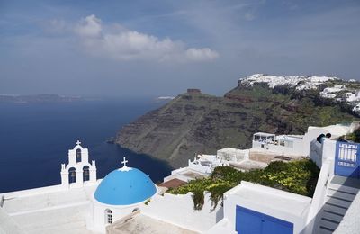 Panoramic view of buildings and mountains against sky