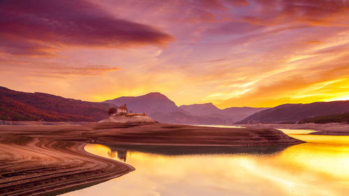 Scenic view of lake against sky during sunset