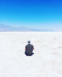 Rear view of man on desert land