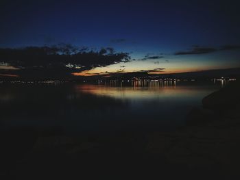 Reflection of illuminated sky in water at night