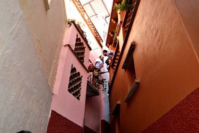 High angle view of people walking on staircase against building