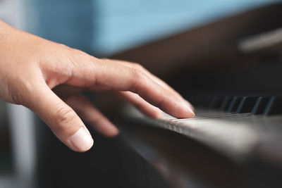 Cropped hand playing piano