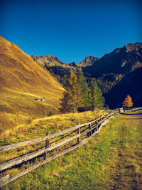 Scenic view of landscape and mountains against blue sky