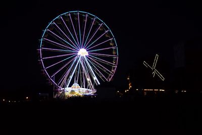 Ferris wheel against sky at night