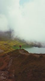 Man standing on mountain against sky