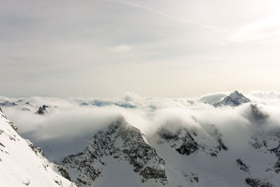 Scenic view of snow covered mountains against sky