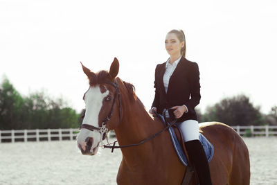 Close-up of horse standing against clear sky