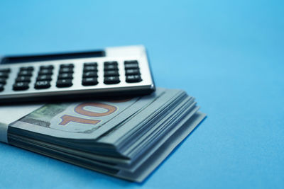 Close-up of telephone booth on table against blue background