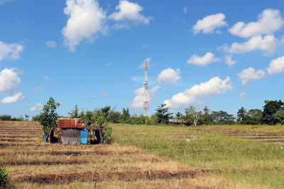 Panoramic view of agricultural field against sky