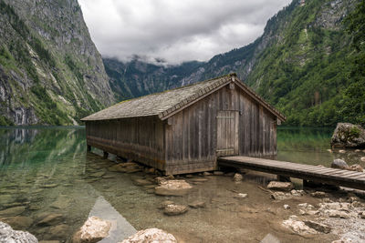 Gazebo by lake against sky