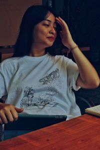 Young woman sitting on table