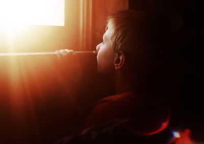 Boy looking through window