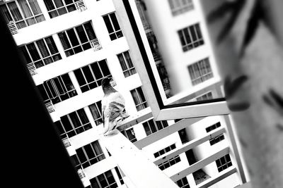 Low section of woman standing by window