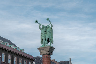 Low angle view of statue against sky