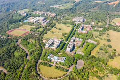 High angle view of houses on field by buildings