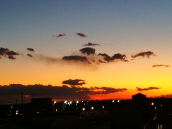 Silhouette city against sky during sunset