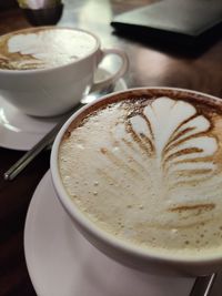 Close-up of cappuccino served on table