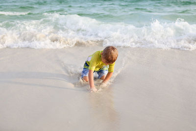 Boy playing at sea shore