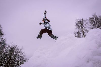 Low angle view of woman jumping