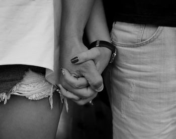 Close-up of couple holding hands