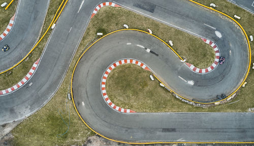 Aerial top view of the go-kart track from the drone. kart racers drive on the open track.