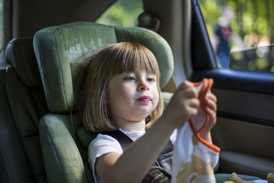 Close-up of girl sitting in car