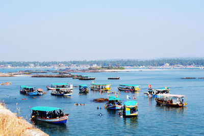 High angle view of boats in sea against clear sky