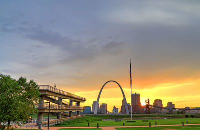 View of bridge and buildings against sky during sunset