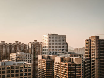 Modern buildings in city against clear sky