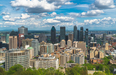 Aerial view of buildings in city against sky