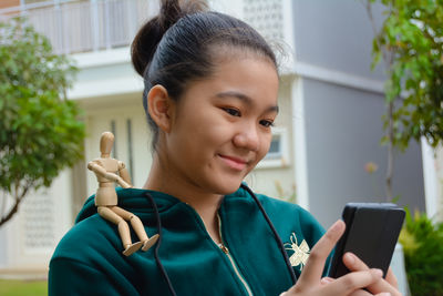 Portrait of smiling man using mobile phone