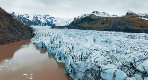 Beautiful glaciers flow through the mountains in iceland.