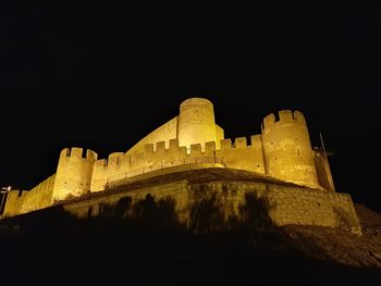 Low angle view of fort at night