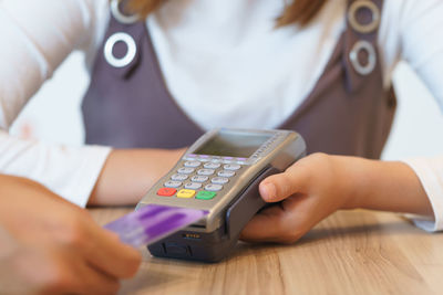 Close-up of woman hand using mobile phone