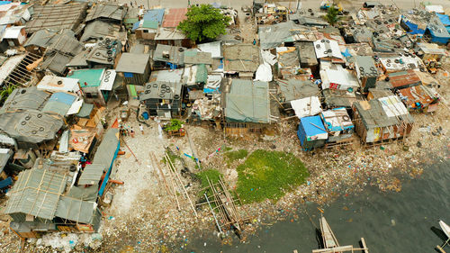 Slums in manila near the port. river polluted with plastic and garbage. manila, philippines.