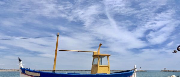 Ship moored on sea against sky